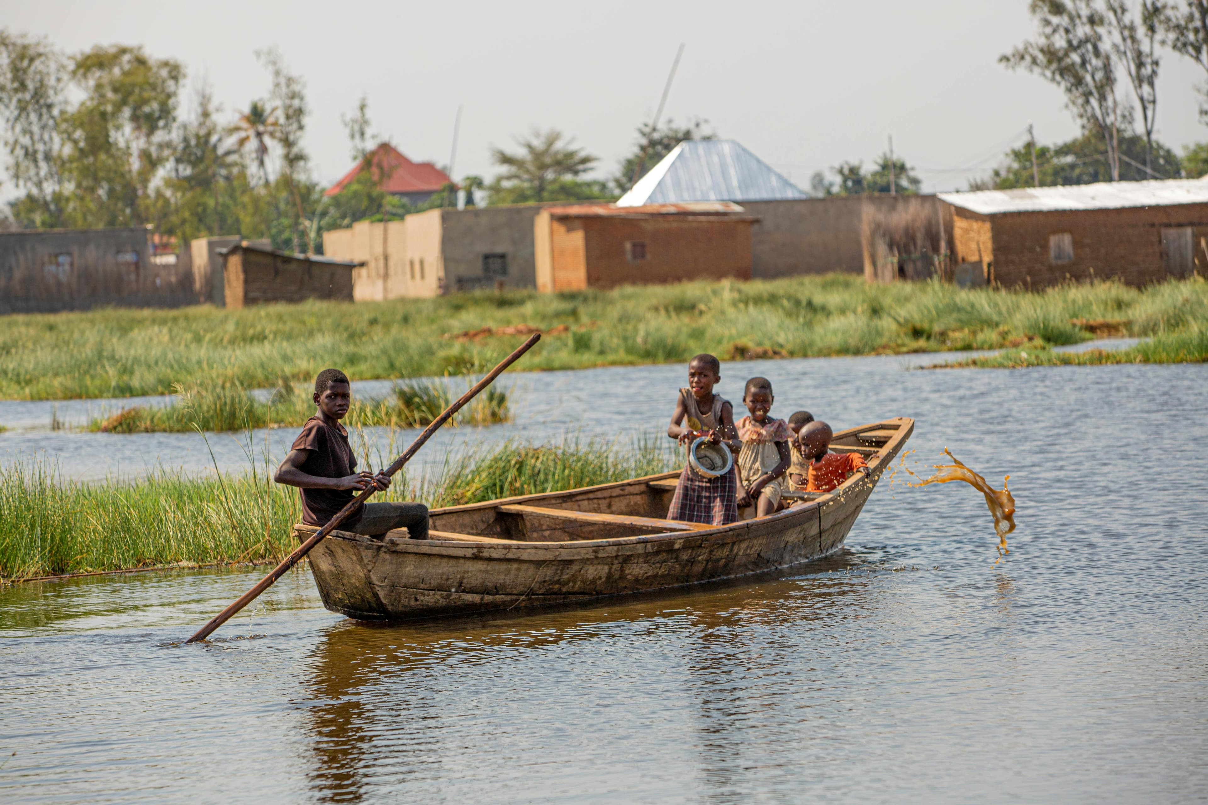 image of kids on a canoe in a swamp