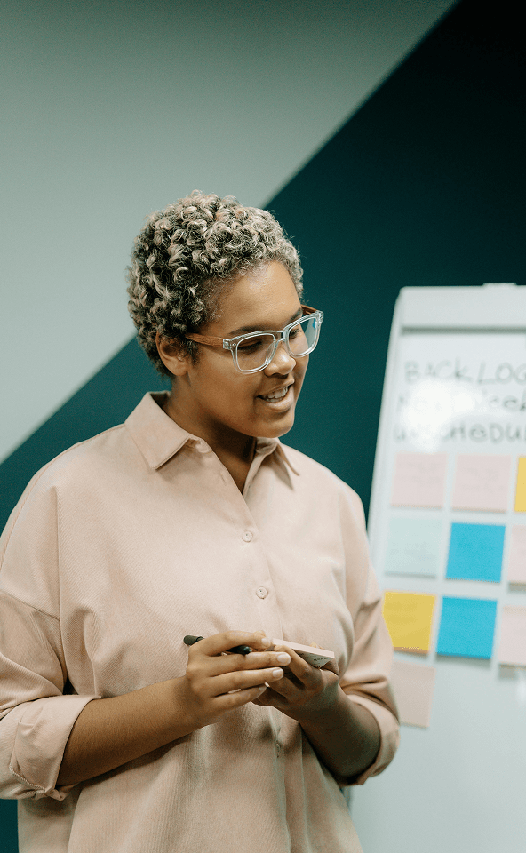 A lady smiling while doing some presentation.